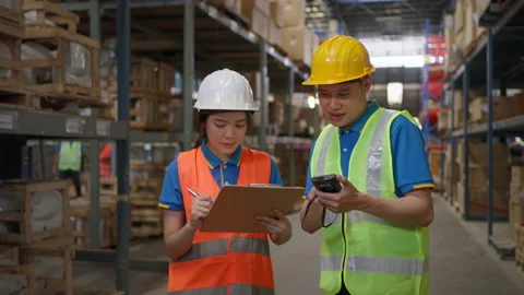 Two warehouse staff checking stock inventory Stock Footage 206356016
