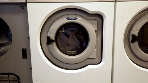 Two washing machines running laundry Stock Footage 124987096