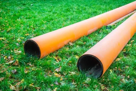 Two water pipes on grass during plumbing repairs under construction Stock Photos