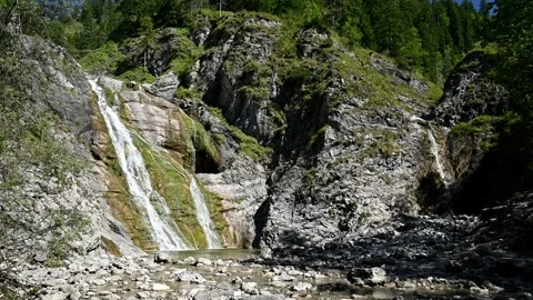 Two waterfalls in an alpine setting in the summer Video stock 260845713