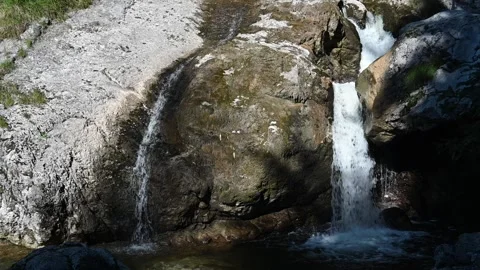 Two waterfalls run over rocks in the summer (slow motion) Stock-Footage 219398378