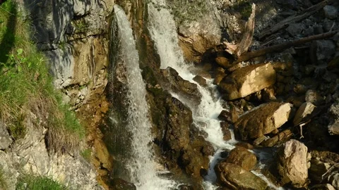 Two waterfalls splash on rocks from a mountain stream Video stock 260931777
