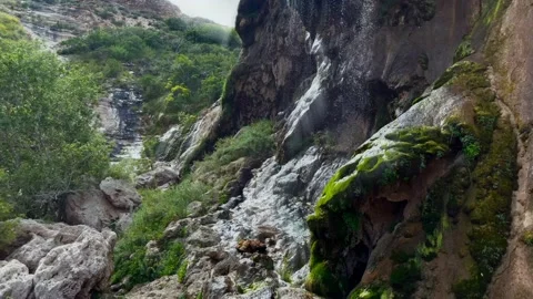 Two waterfalls with sun rays streaming from the top Stock Footage 214392467