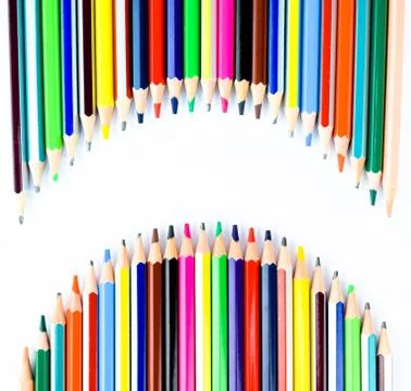 Two waved row of different colored pencil crayons making a blank space to wri Stock Photos