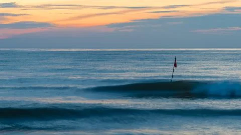 Two waves an a red flag Stock Photos