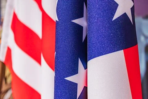 Two waving American flags in motion, side by side against an indistinct ind.. Stock Photos