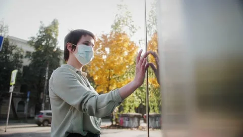 Two-way interactive touchscreen kiosk. Woman in medical mask tapping on sensory Stock Footage 140366069