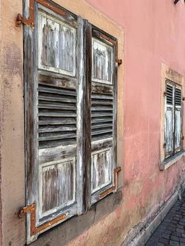 Two weathered window shutters create interesting European still life scene Stock Photos