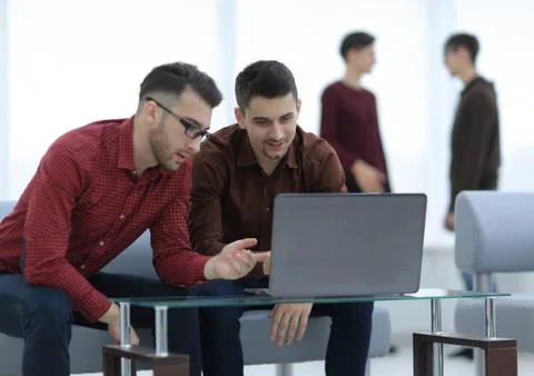 Two web designers discussing a project Stock Photos