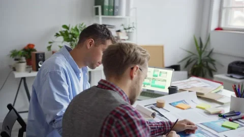 Two web designers working on app interface at desk Stock Footage 142526710