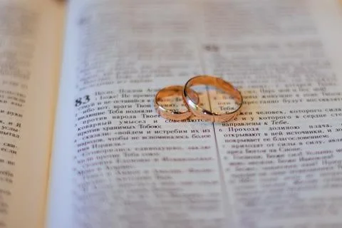 Two wedding rings on a bible Stock Photos