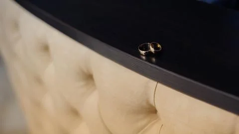 Two wedding rings on a brown background Stock Photos