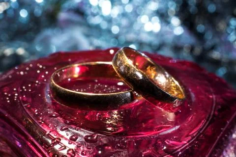 Two wedding rings of different sizes made in gold on the red crystal Stock Photos
