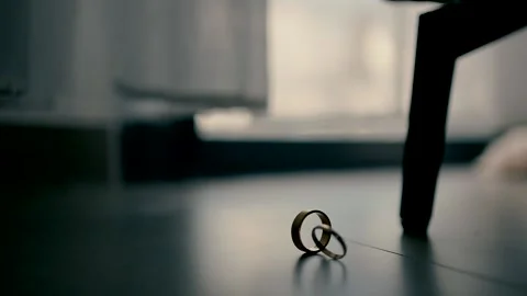 Two wedding rings on the floor by the window Stock Footage 233292012