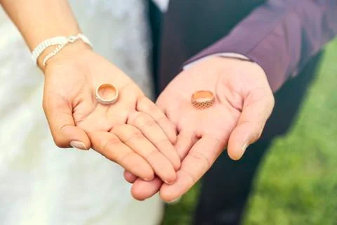 Two wedding rings in the hands Stock Photos