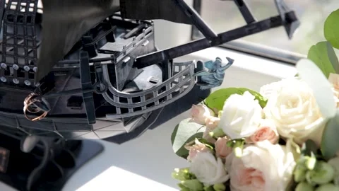 Two wedding rings hang on a decorative, vintage, pirate ship Stock Footage 249010907