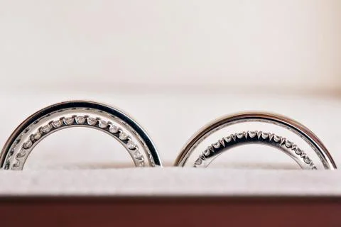 Two wedding rings in infinity sign. Love concept. the wedding of two sisters Stock Photos