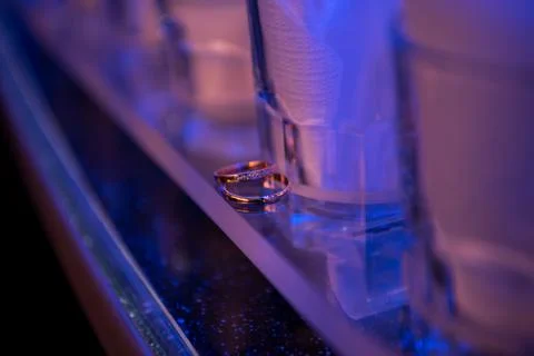 Two wedding rings on a mirror surface close-up. Stock Photos