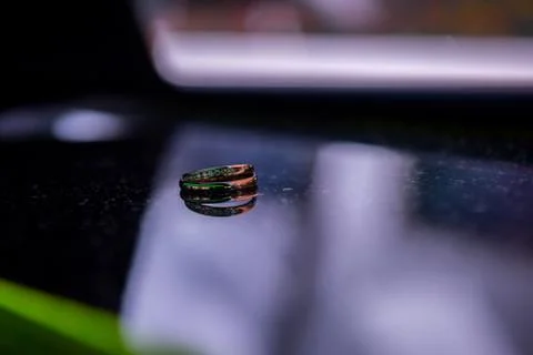 Two wedding rings on a mirror surface close-up. Stock Photos