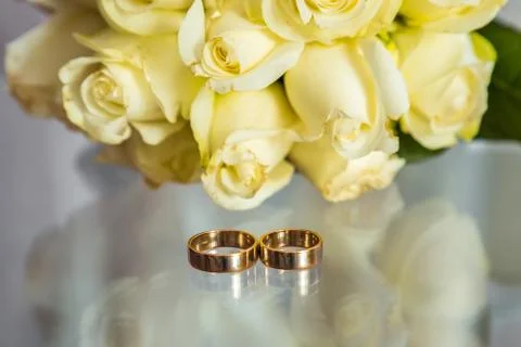 Two wedding rings next to the window Stock Photos