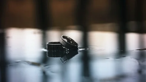 Two wedding rings in the rain. Slow motion Stock Footage 87994370