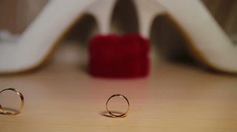 Two Wedding Rings Rolling On The Table Stock Footage 50293944
