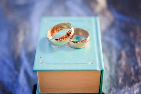 Two wedding rings on small book. Stock Photos