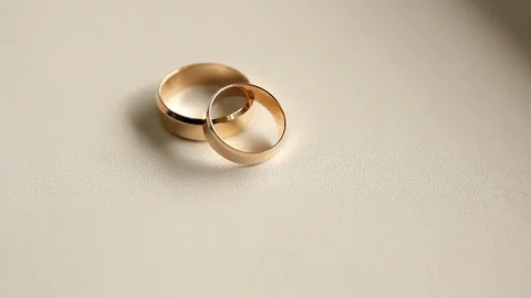 Two wedding rings on a white background, moving camera Stock Footage 91200588