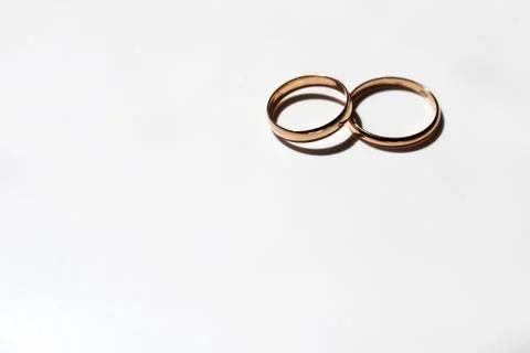 Two wedding rings on a white background. Selective focus. Stock Photos