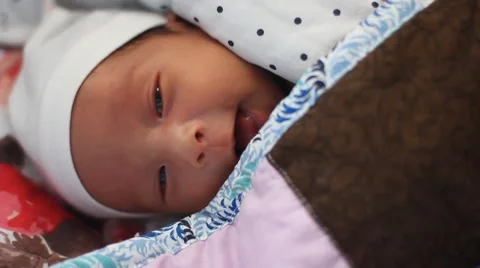 Two weeks old cute baby smiling and keeping his eyes open behind the blanket Stock Footage 55438643