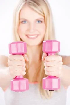 Two weights in woman's hands Stock Photos