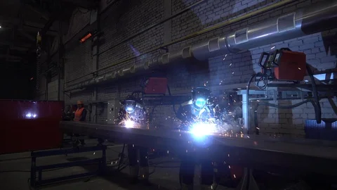 Two Welders in protective workwear at mechanical hangar. Workmans Video stock 104309807