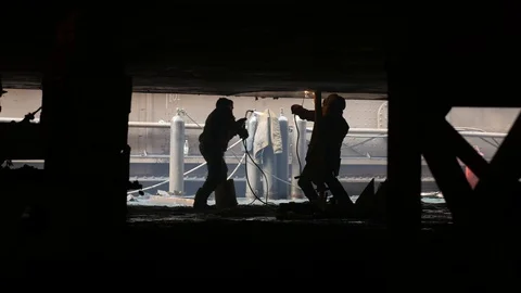 Two welders under the ship in the dock, install a jack Stock Footage 87320413