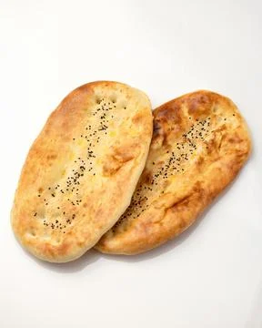Two wheat bread buns with sesame seeds. Whole loafs shadow isolated on white Stock Photos