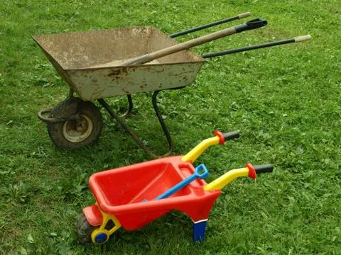 Two wheelbarrows on green to a grass. Stock Photos