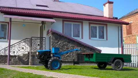 Two wheeled tractor on the background of the house Stock Footage 151474341