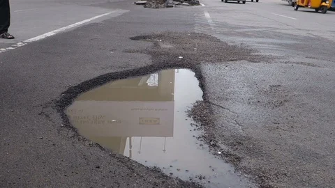 A two wheeler bumpy ride over a pothole Stock Footage 119525459