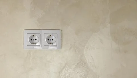 Two white 220W high voltage European sockets on a white wall with space for text Stock Photos