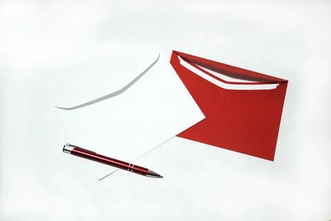Two white and red envelopes on white background. Stock Photos