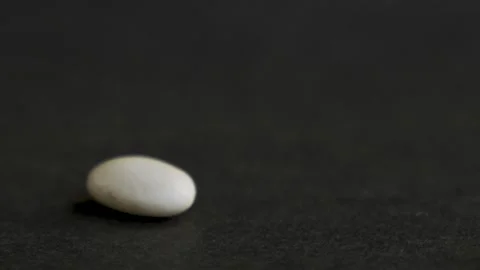Two white beans colliding on black background 10bit 120fps Видео 332748044