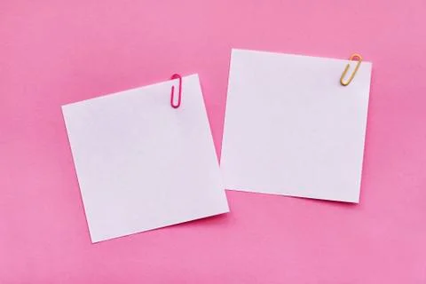 Two white blank note papers with clips on bright pink background Stock Photos
