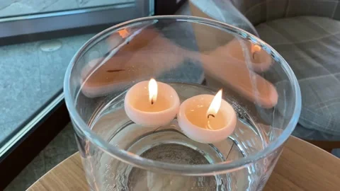 Two white burning candles decorate the room, create a calm atmosphere. Stock Footage 239342990