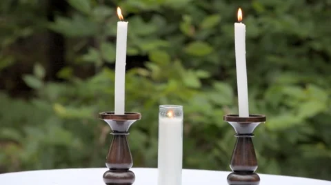 Two White Candles Burning at Wedding Ceremony on White Linen Table Stock Footage 58102660