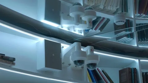 Two white circular security cameras and a fire alarm sensor on a mirror ceiling Video stock 287957188