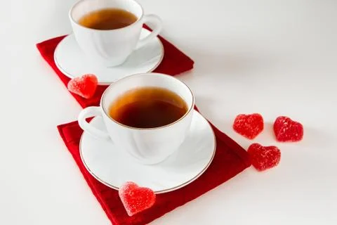 Two white cups of tea. The concept of a meeting of two lovers. Stock Photos