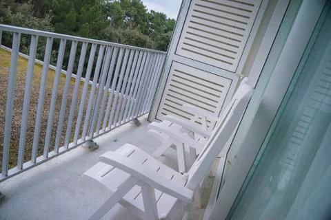 Two white deck chairs on the balcony Stock-Fotos