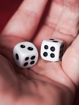 Two white dice in a hand Stock Photos