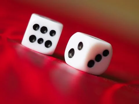 Two white dice on a red table Stock Photos