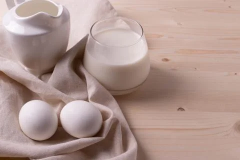 Two white eggs and milk as calcium concept. minimalism style. Stock Photos