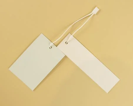 Two white empty labels on a beige background. Tags for prices or product names. 스톡 사진